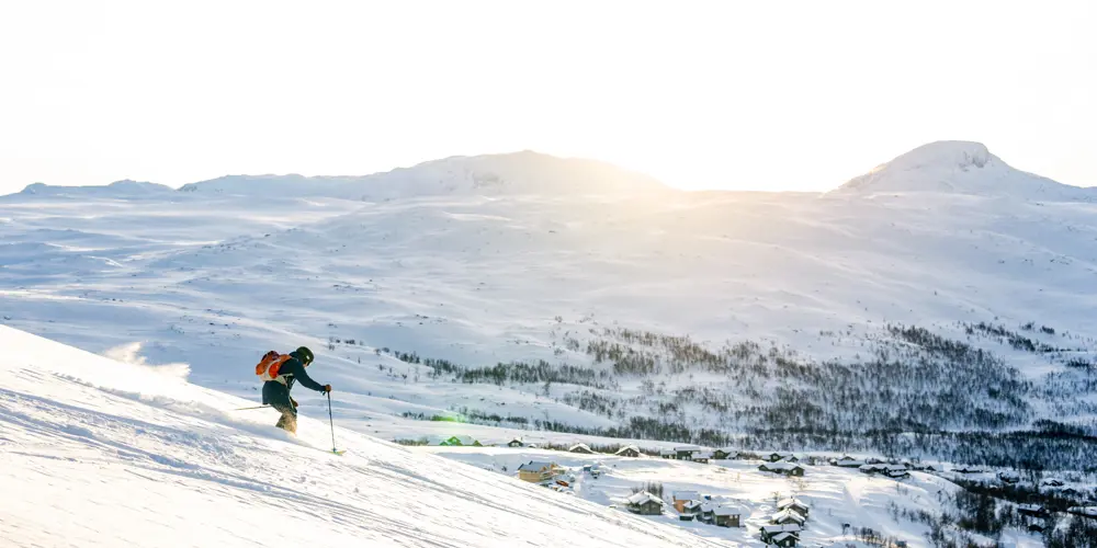 Skiers speeding down the slopes at Tyin Filefjell Ski Center
