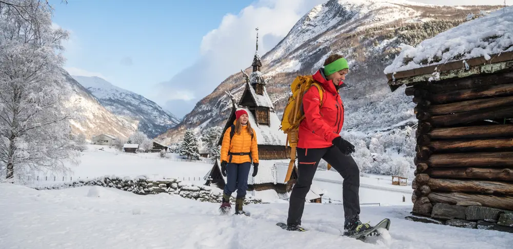 Two people on a snowshoe hike on Kongevegen, by Borgund Stave Church