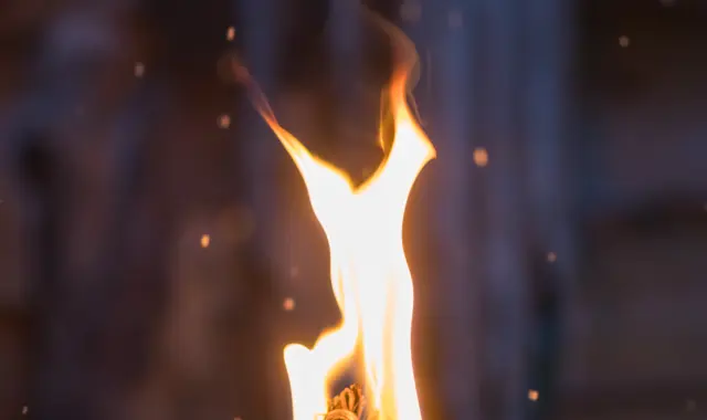 Fire Burning Inside Metal Torch In Front Of A Wood 2025 10 13 01 30 02 Utc