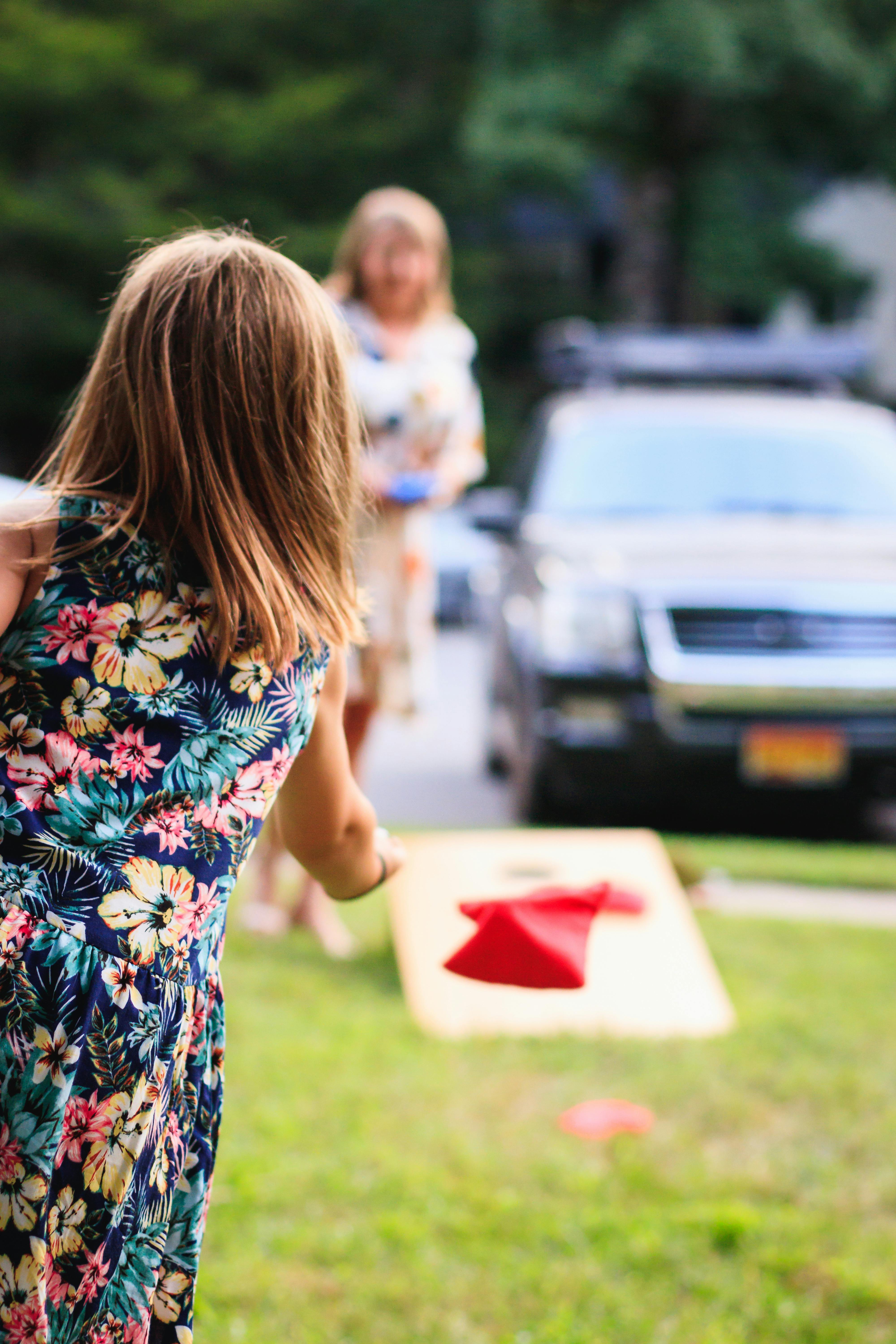 Young girl playing cornhole
