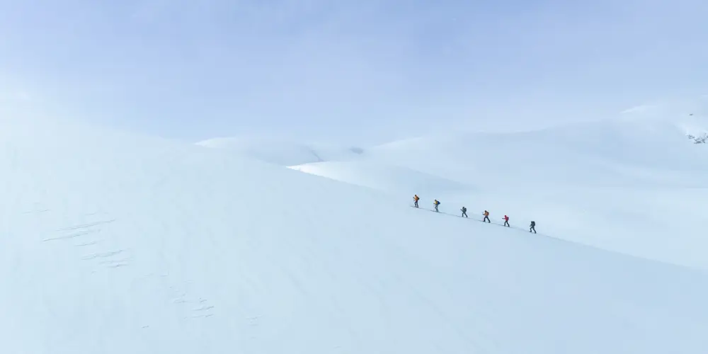 Oversigt over deltagere på en randonnée- og topturrute op ad bakke i et smukt vinterlandskab