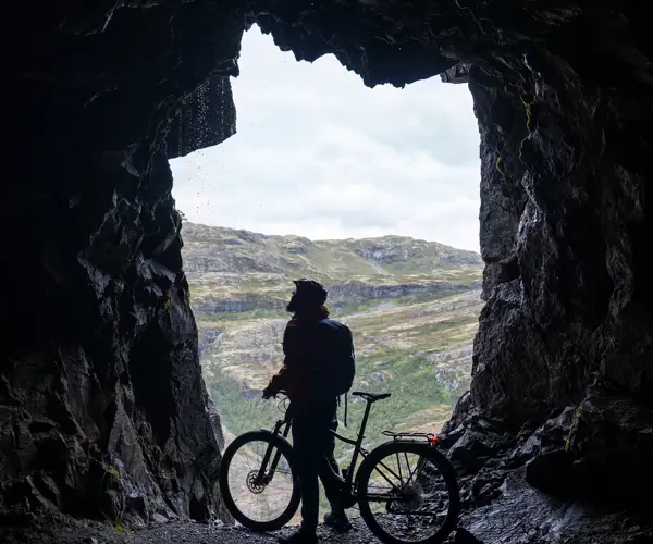 Cyclist in one of the tunnels along Tusenmeteren in Øvre Årdal