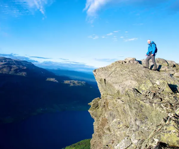 Hiker looks at the view from Uksestigen in Vang