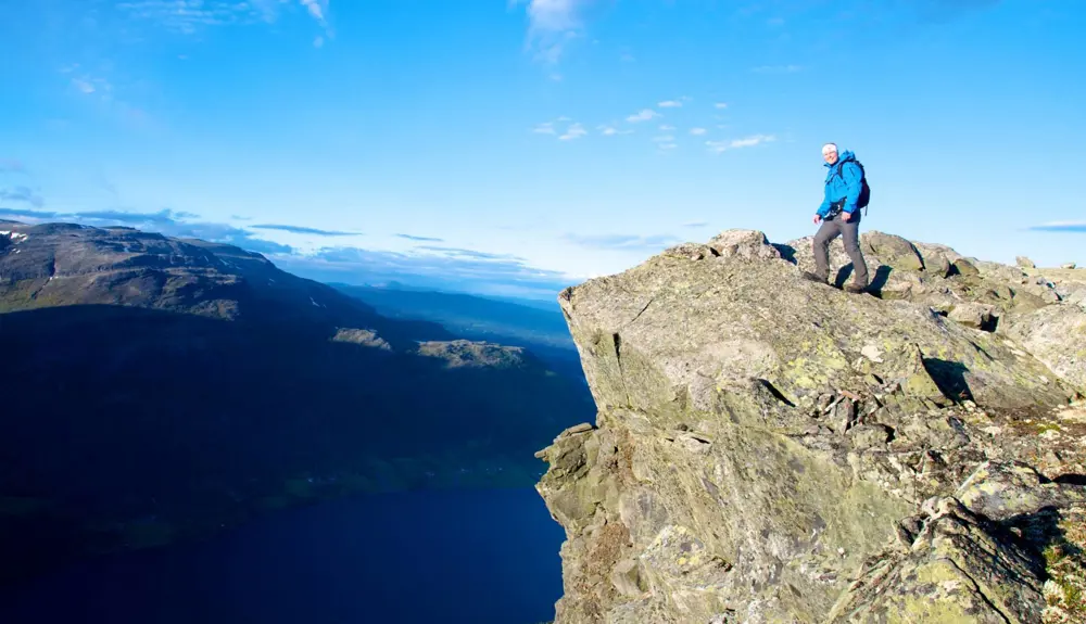 Hiker looks at the view from Uksestigen in Vang
