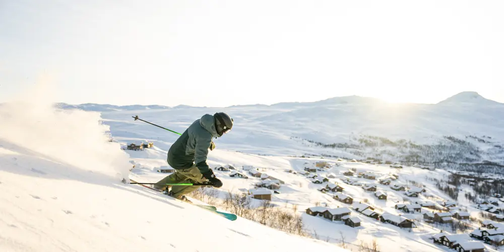 Skiers speeding down the slopes at Tyin Filefjell Ski Center